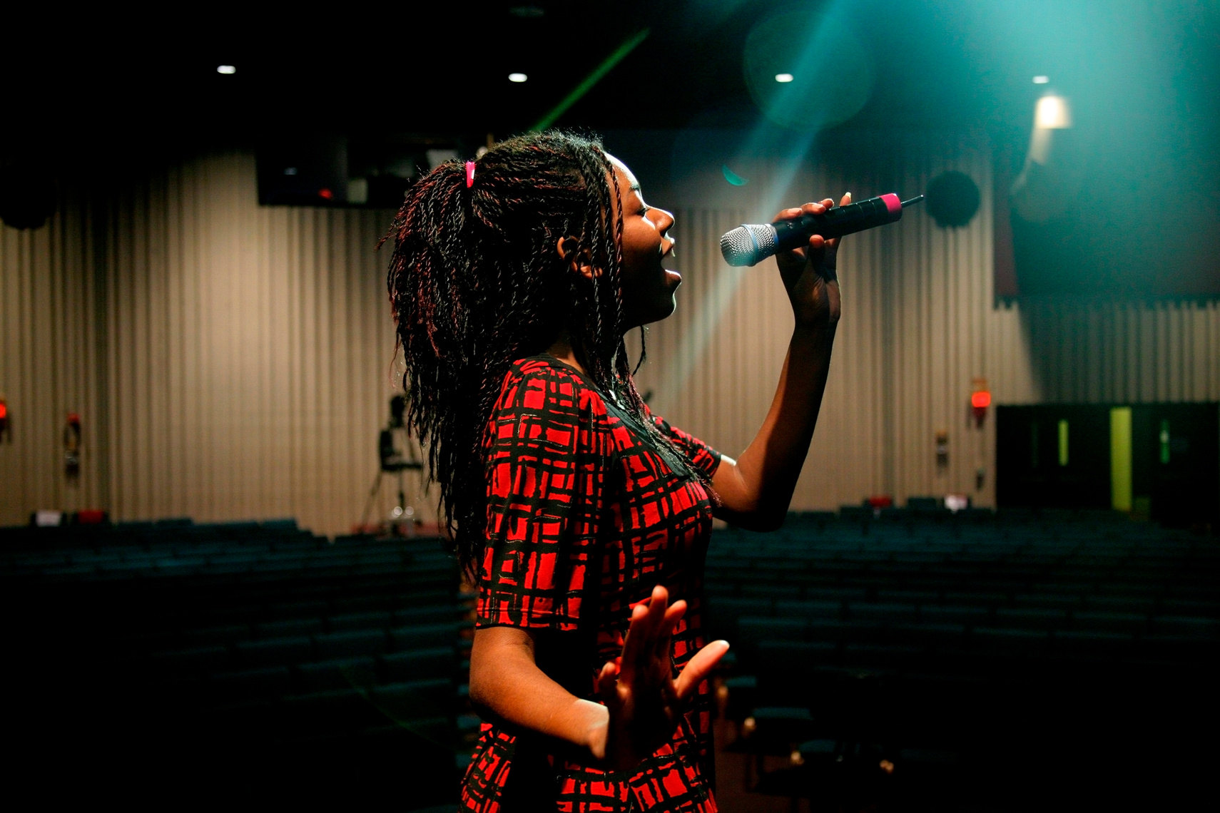 Woman Singing in an Auditorium