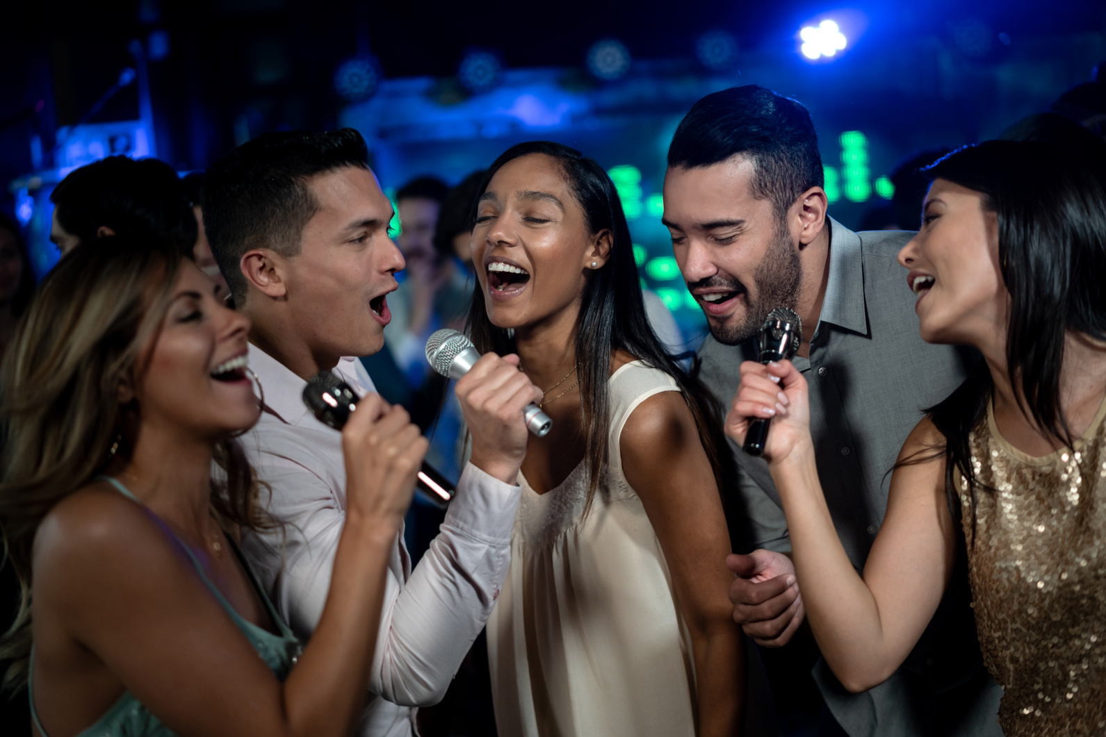 Group of people singing on karaoke night at a bar